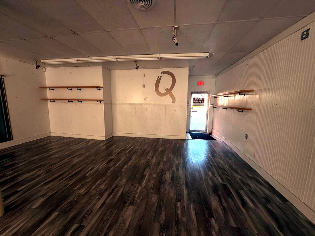 Rear room with shelving and separate street entrance